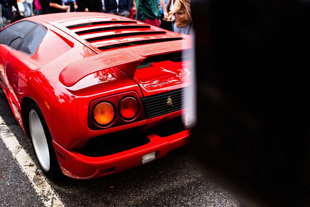 sports car red luxury car parked on concrete road automobile